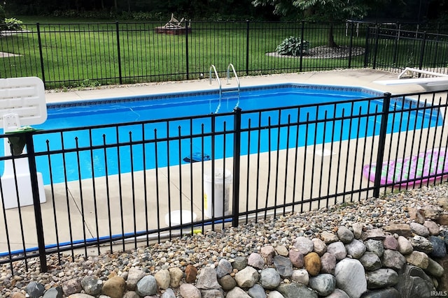 view of pool with a lawn, fence, and a fenced in pool