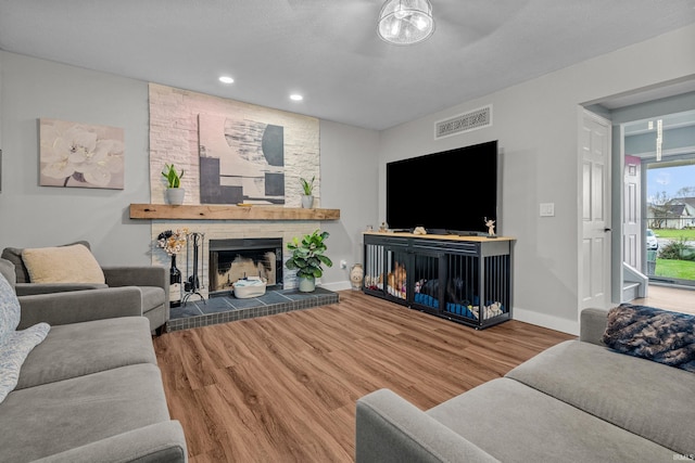 living room with hardwood / wood-style floors and a fireplace