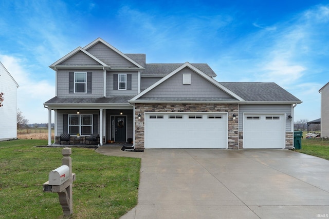 craftsman-style home with a front yard, a porch, and a garage