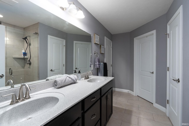 bathroom with tile patterned floors, vanity, and an enclosed shower