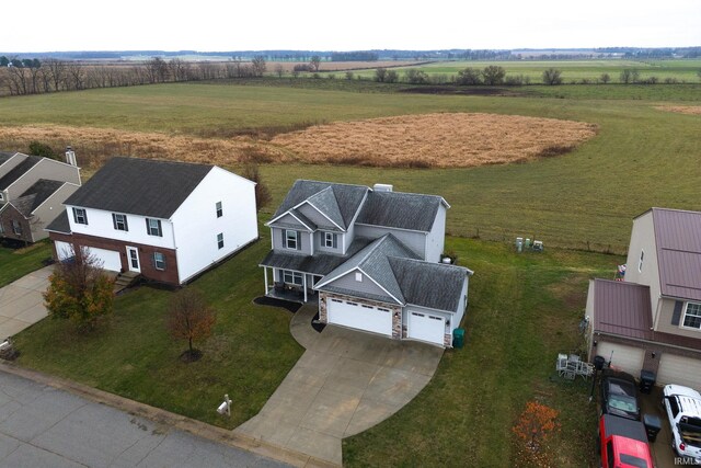 birds eye view of property with a rural view