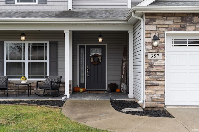 view of exterior entry featuring covered porch