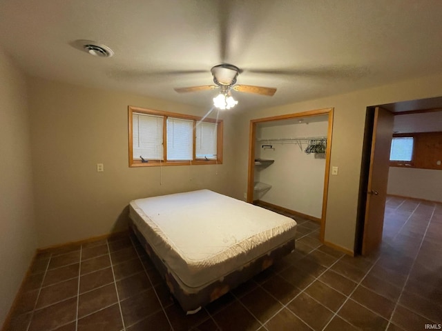 tiled bedroom featuring a closet and ceiling fan