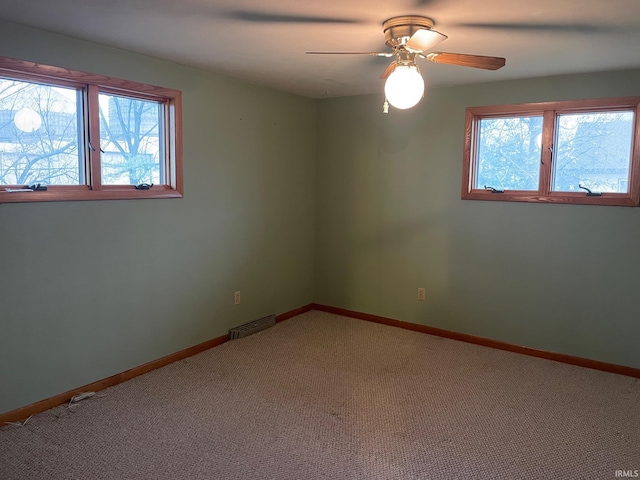 empty room with carpet flooring and ceiling fan