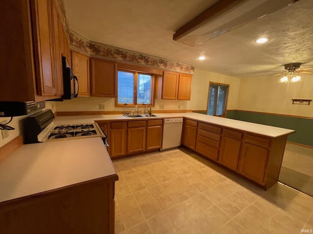 kitchen featuring kitchen peninsula, ceiling fan, sink, and white appliances