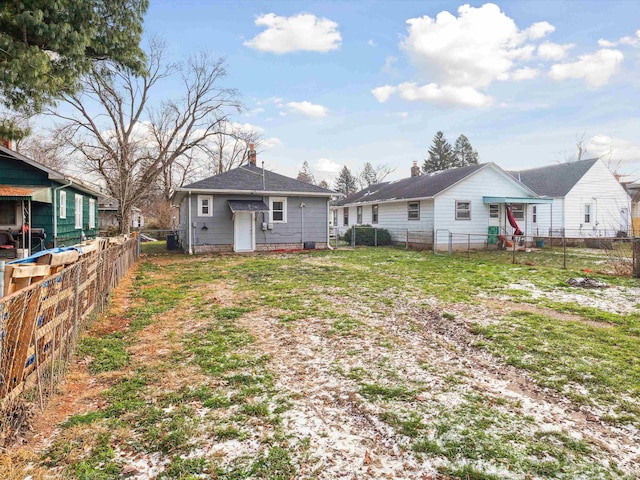 rear view of house with a yard