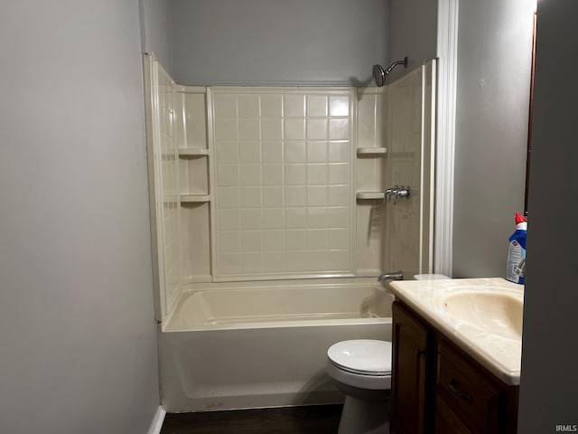 full bathroom with hardwood / wood-style floors, vanity, toilet, and shower / tub combination