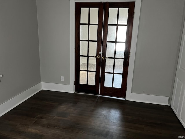 doorway to outside featuring french doors and dark wood-type flooring