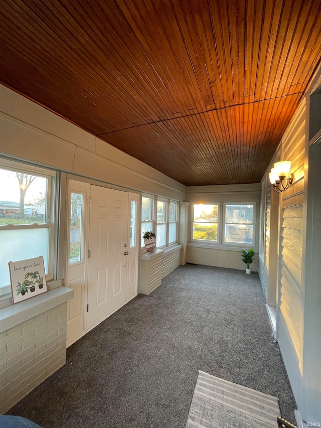 unfurnished sunroom with wood ceiling and lofted ceiling