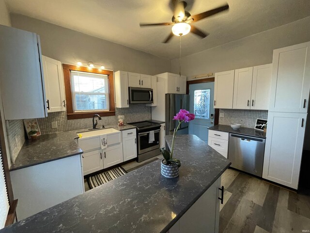 531 E 5th St, Mount Vernon, IN 47620 - kitchen featuring appliances with stainless steel finishes, tasteful backsplash, and white cabinetry