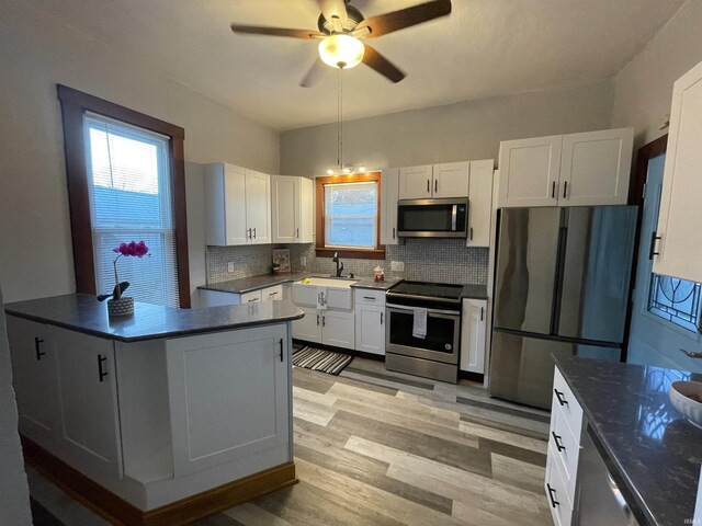 531 E 5th St, Mount Vernon, IN 47620 - kitchen featuring stainless steel appliances, a sink, backsplash, white cabinetry, and a ceiling fan
