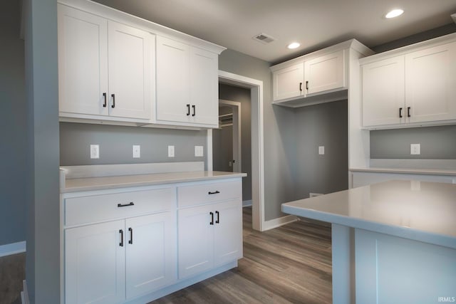 kitchen with white cabinets and dark wood-type flooring