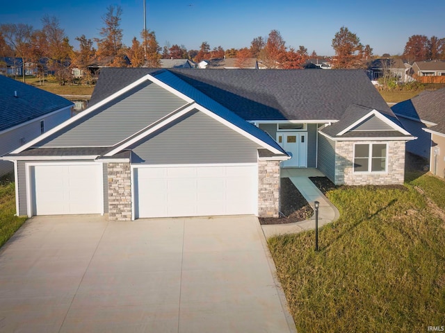 craftsman-style house featuring a garage and a front lawn