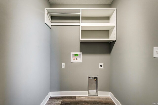 laundry room with electric dryer hookup, washer hookup, a textured ceiling, and hardwood / wood-style flooring