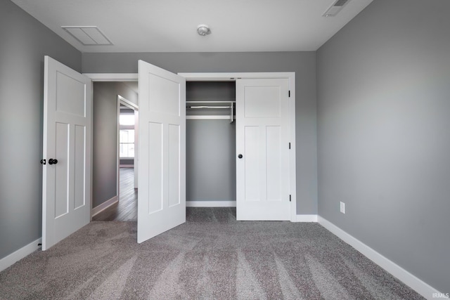 unfurnished bedroom featuring carpet and a closet