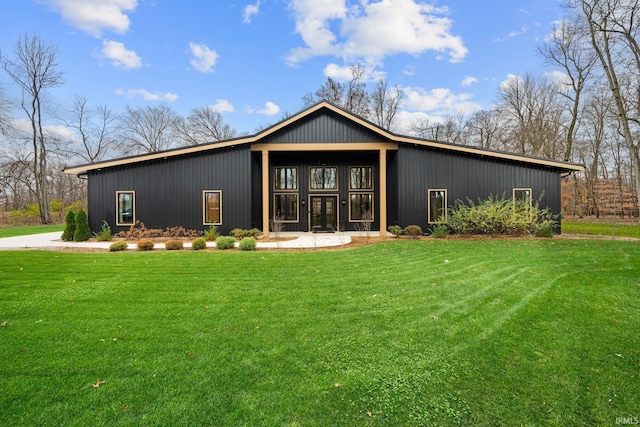 rear view of property featuring a lawn