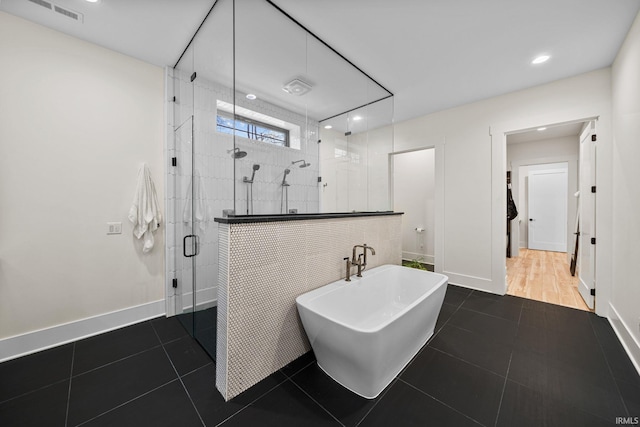 bathroom with tile patterned flooring and independent shower and bath