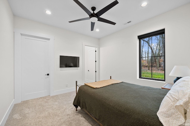 bedroom with ceiling fan and light colored carpet