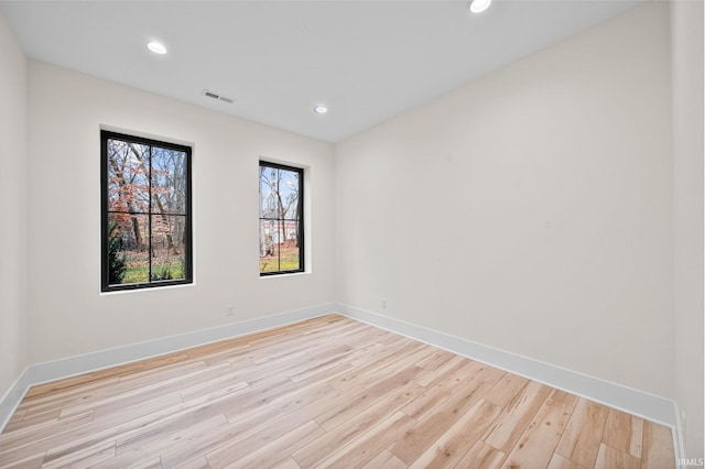 spare room featuring light wood-type flooring