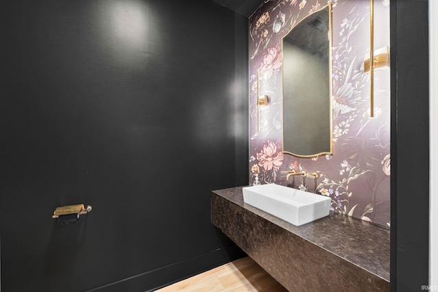 bathroom with hardwood / wood-style floors and sink