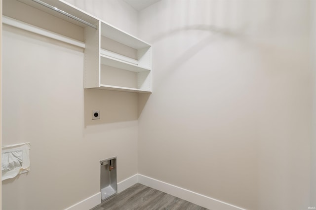 laundry area featuring hookup for an electric dryer and wood-type flooring