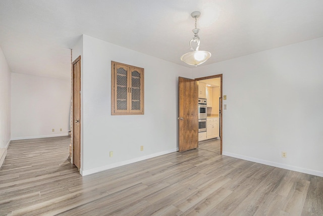 empty room with light hardwood / wood-style floors