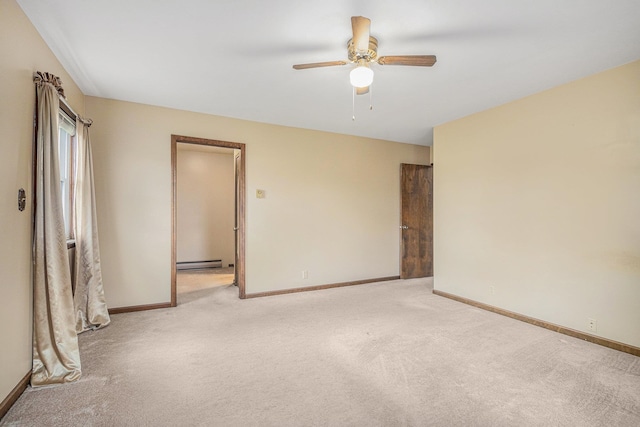 carpeted spare room with ceiling fan and a baseboard radiator