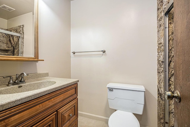 bathroom with tile patterned floors, vanity, toilet, and a shower with shower door