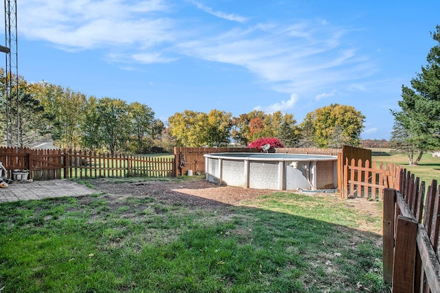 view of yard with a fenced in pool