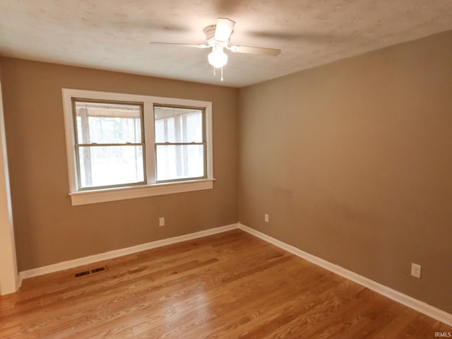 empty room featuring light hardwood / wood-style flooring and ceiling fan