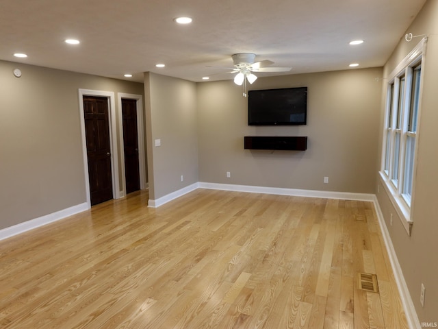 unfurnished living room featuring light hardwood / wood-style floors and ceiling fan