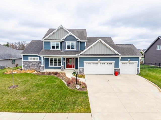 craftsman-style home with central air condition unit, a front lawn, and a garage