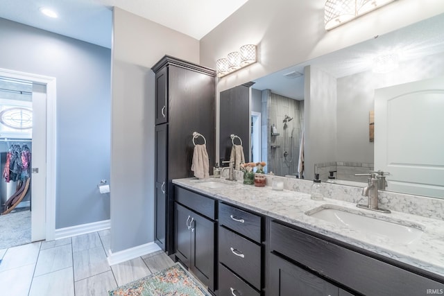 bathroom featuring tile patterned flooring, vanity, and walk in shower