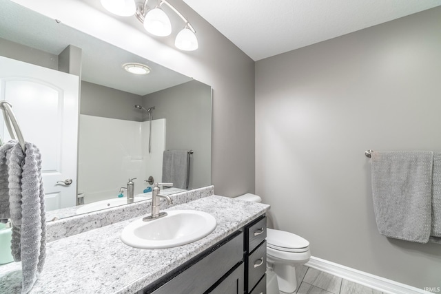 bathroom featuring vanity, toilet, and walk in shower