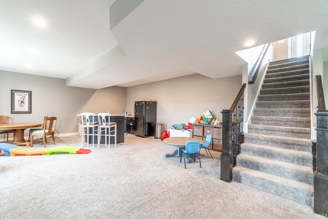 playroom featuring a textured ceiling and carpet floors