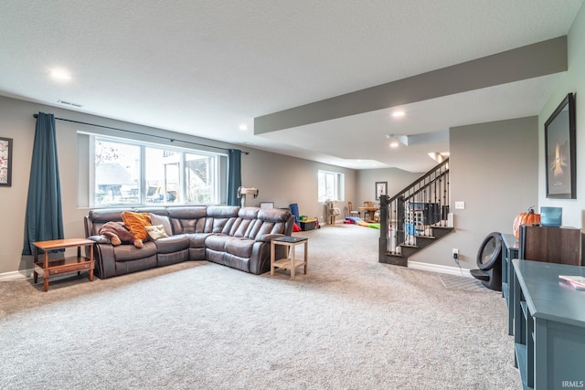 carpeted living room featuring a textured ceiling