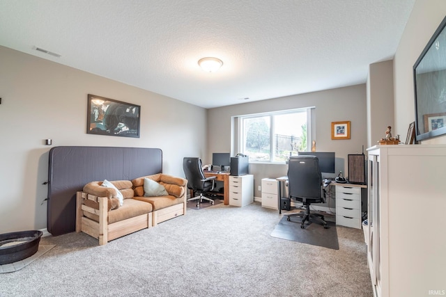 home office featuring carpet and a textured ceiling