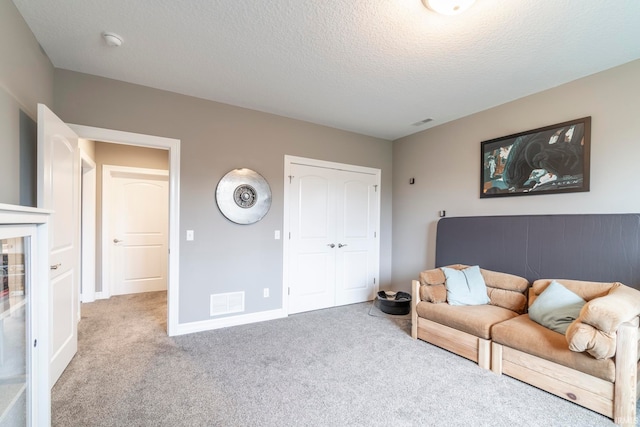 living room with a textured ceiling and light carpet