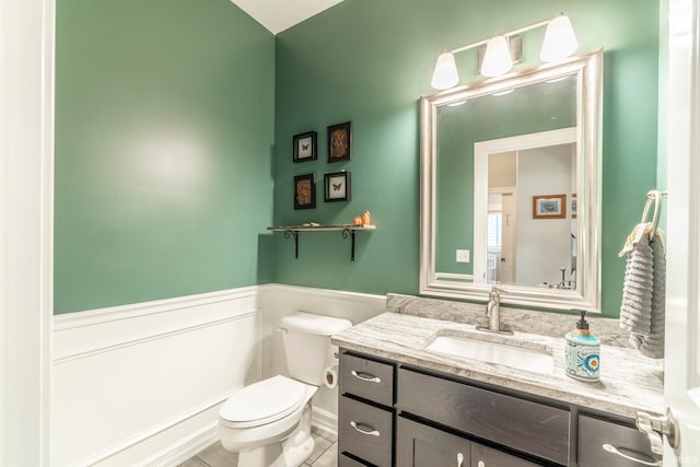 bathroom with tile patterned floors, vanity, and toilet