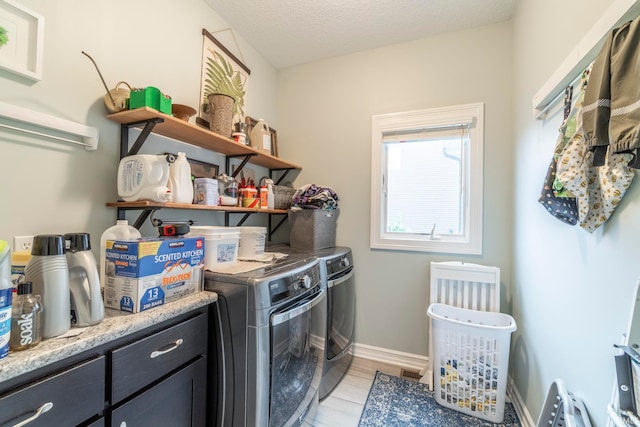 laundry room with washer and clothes dryer and a textured ceiling