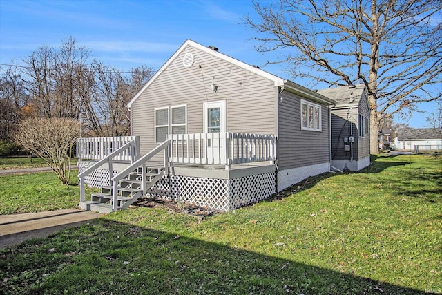 view of side of home featuring a lawn and a deck