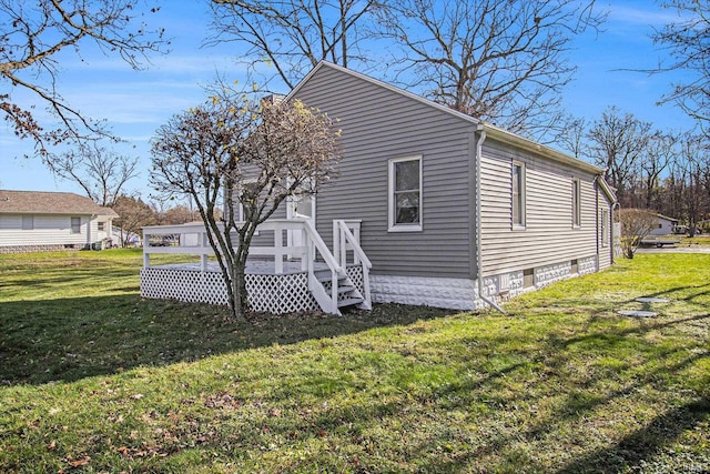 view of side of home featuring a deck and a yard