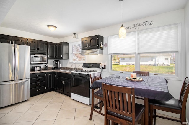 kitchen featuring pendant lighting, light tile patterned flooring, stainless steel appliances, and sink