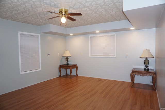 empty room with wood-type flooring and ceiling fan