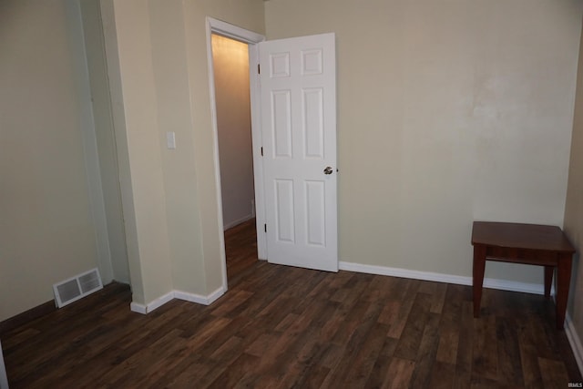 unfurnished room with dark hardwood / wood-style flooring