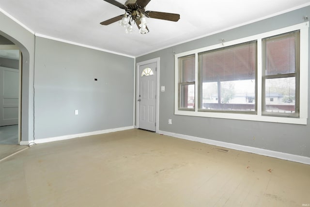 empty room with ceiling fan and ornamental molding