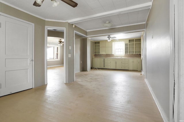 empty room featuring crown molding, a healthy amount of sunlight, and light wood-type flooring