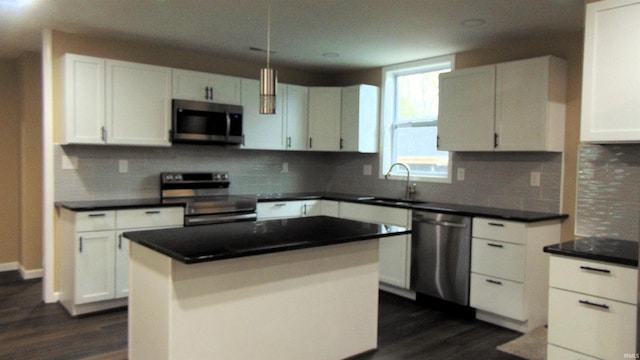 114 E Mill St, Oakland City, IN 47660 - kitchen with stainless steel appliances, a sink, white cabinetry, dark wood finished floors, and decorative backsplash