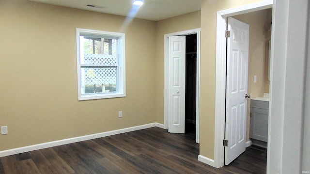 114 E Mill St, Oakland City, IN 47660 - unfurnished bedroom featuring baseboards and dark wood-style floors