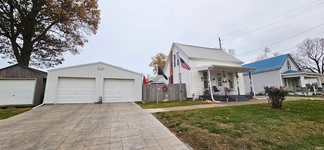 view of front facade with a front lawn, an outdoor structure, and a garage